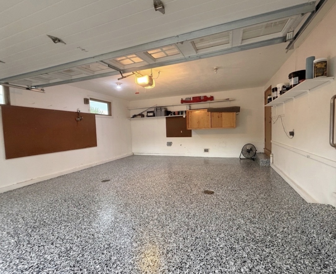 Same Omaha garage with a gray and black flake polyaspartic floor coating